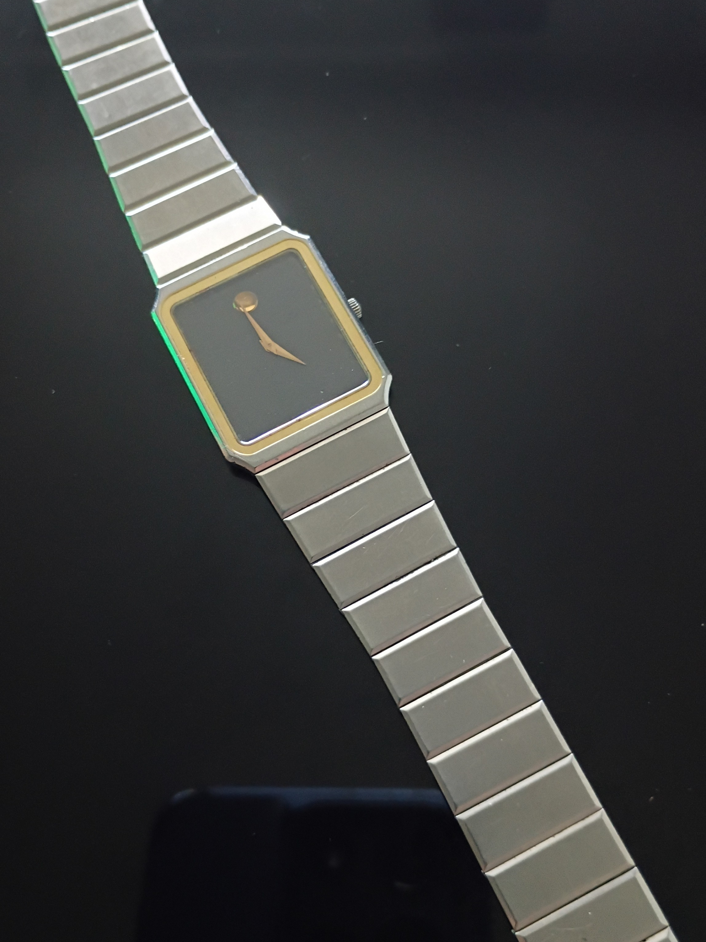 Movado Silver Stainless Steel Bracelet Watch With Black Dial And Gold Accents